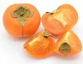 Persimmons Japanese raw, cross-section of one. Kaki fruit red color.