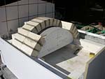 Making masterly tail oven firebrick arches.
