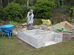Raising block walls with dry stack cement blocks filled with concrete.