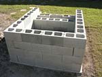 Raising block walls with dry stack cement blocks filled with concrete.