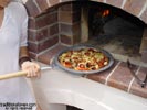 Fired brick wood oven for pizzas or breads.