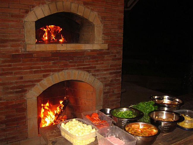 Mto brick oven with fireplace under a hut