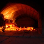 Firing up brick pizza oven.