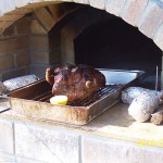 Leg of lamb roasted in Masterly Tail brick oven design.