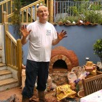 Mixing clay sand for building earth cob pizza oven.