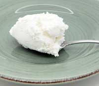 Larger silver spoon of coconut yogurt.