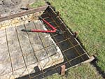 Cutting reinforcing mess to fit slab area.