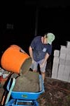Mixing the last wheelbarrow of concrete.