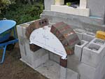 Building entry surface hearth and first decorative arch from house bricks.