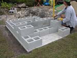 Raising block walls with dry stack cement blocks filled with concrete.