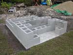 Raising block walls with dry stack cement blocks filled with concrete.