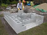 Raising block walls with dry stack cement blocks filled with concrete.