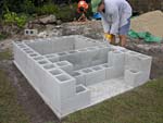 Raising block walls with dry stack cement blocks filled with concrete.