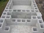 Raising block walls with dry stack cement blocks filled with concrete.