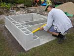 Raising block walls with dry stack cement blocks filled with concrete.