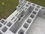 Raising block walls with dry stack cement blocks filled with concrete.