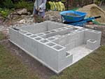 Raising block walls with dry stack cement blocks filled with concrete.