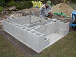 Raising block walls with dry stack cement blocks filled with concrete.