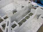 Raising block walls with dry stack cement blocks filled with concrete.