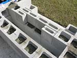 Raising block walls with dry stack cement blocks filled with concrete.