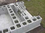 Raising block walls with dry stack cement blocks filled with concrete.