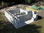 Raising block walls with dry stack cement blocks filled with concrete.