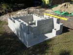 Raising block walls with dry stack cement blocks filled with concrete.