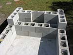 Raising block walls with dry stack cement blocks filled with concrete.