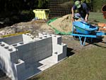 Raising block walls with dry stack cement blocks filled with concrete.