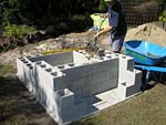 Raising block walls with dry stack cement blocks filled with concrete.