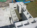 Raising block walls with dry stack cement blocks filled with concrete.