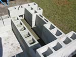 Raising block walls with dry stack cement blocks filled with concrete.