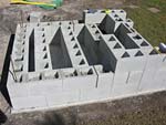 Raising block walls with dry stack cement blocks filled with concrete.