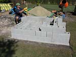 Raising block walls with dry stack cement blocks filled with concrete.