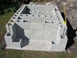 Raising block walls with dry stack cement blocks filled with concrete.
