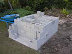 Raising block walls with dry stack cement blocks filled with concrete.