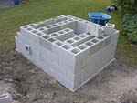 Raising block walls with dry stack cement blocks filled with concrete.