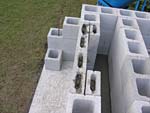 Raising block walls with dry stack cement blocks filled with concrete.