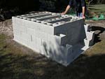 Raising block walls with dry stack cement blocks filled with concrete.