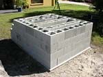 Raising block walls with dry stack cement blocks filled with concrete.