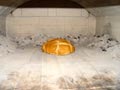 Bread baking in a brick wood oven.