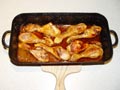 Chicken pieces in a lemon sauce grilled in wood fired oven.