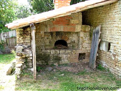 Picture of a stone wall house and wood oven built in 1930 in France.