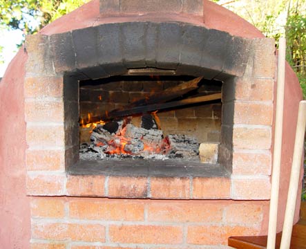 Picture of fire inside the oven located next to the house.