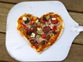 Picture of a love heart pizza.