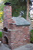 Flue and brick chimney with steel cap.