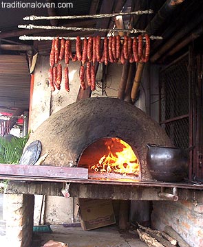 Smoked sausages on smoke from wood fire, picture.