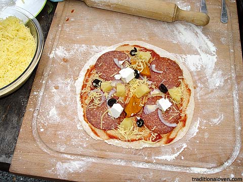 Making pizza picture, rolling dough base, toppings.