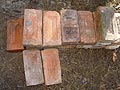 Photograph of old solid red clay building bricks.
