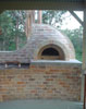 Wood oven with the chimney at the back.